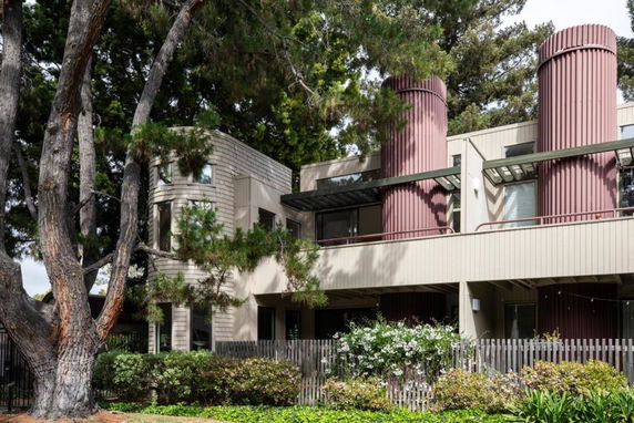Front view of a multi-story building with unique cylindrical structures.