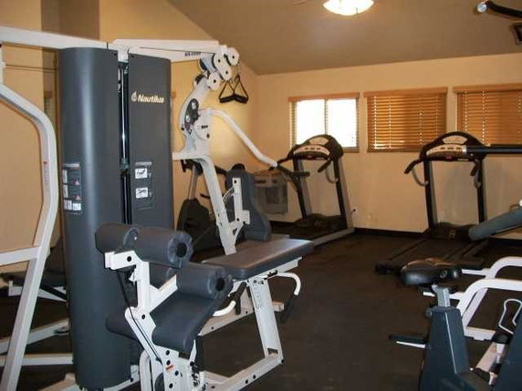Indoor gym area with exercise equipment including treadmills and a multi-gym machine.