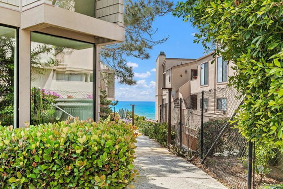 View of residential buildings with ocean in the background.