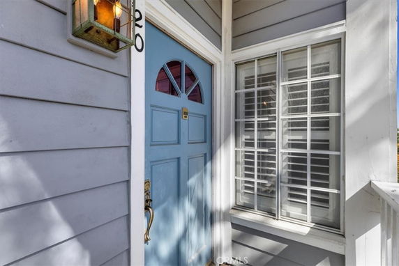 Front entry view with blue door and adjacent window.