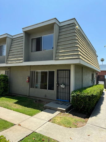 Front view of a two-story building with a flat roof.