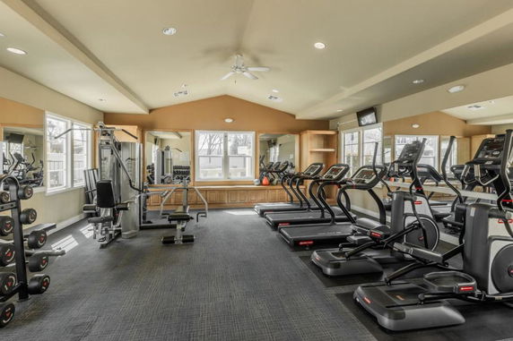 Fitness room with treadmills and gym equipment.