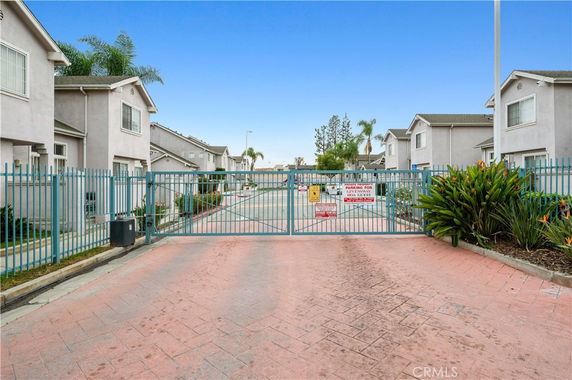 Front view of a residential complex with gated entrance.
