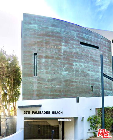 Front view of a modern multi-story building with a distinctive curved facade.
