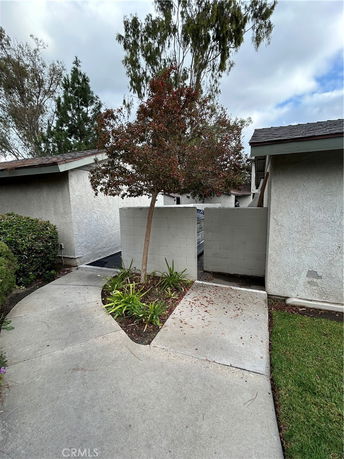 Front view of a house with a walkway and a small garden area.