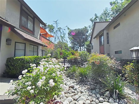 Front view of a multi-story residential building with landscaping.