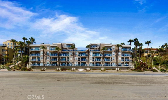 Front view of a multi-story beachfront building.