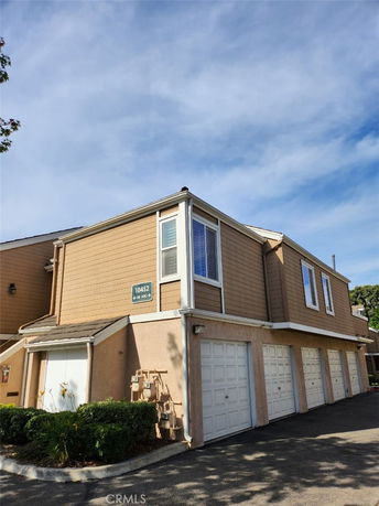 Front view of a two-story building with multiple garages.