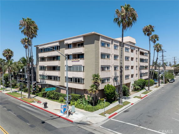 Front view of a multi-story apartment building on a corner lot.