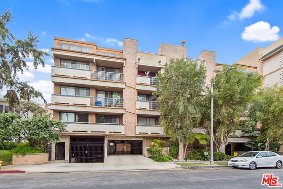 Front view of a multi-story residential building with balconies.