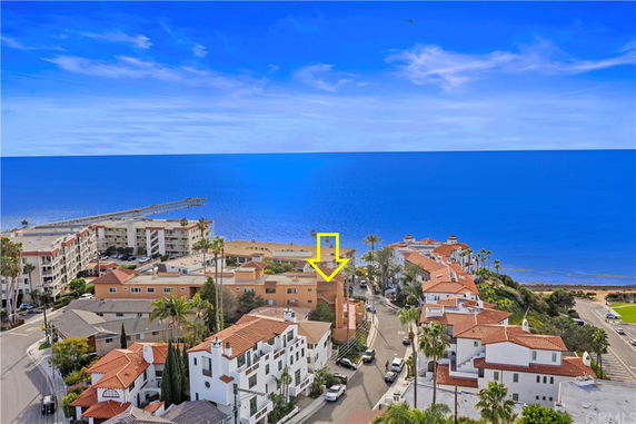 Wide angle view of buildings near the coast with the ocean in the background.