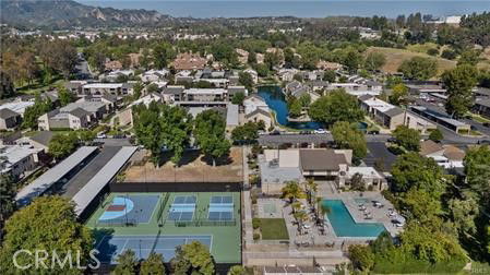 Wide angle view of a residential area with tennis courts and a swimming pool.
