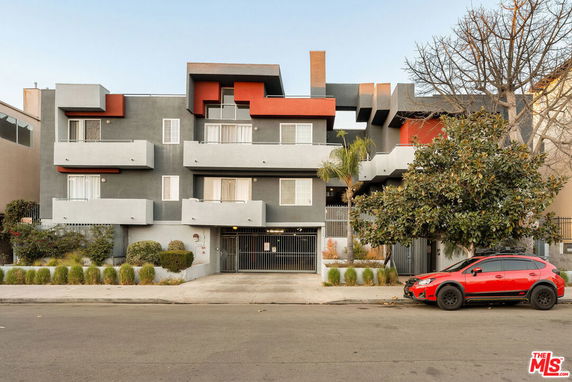 Front view of a three-story apartment building with modern design elements.