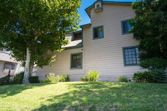 Front view of a two-story house with green trim.