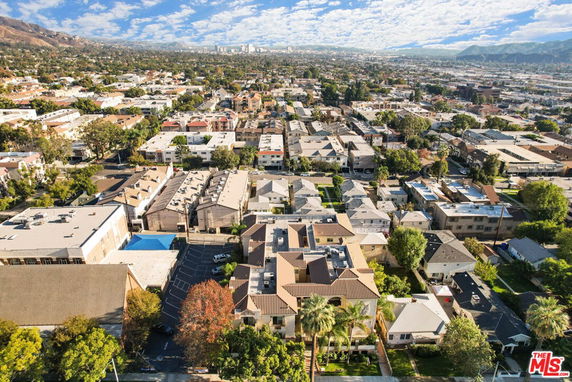 Panoramic aerial view of a residential neighborhood with houses and buildings.
