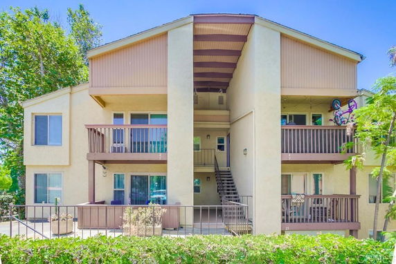 Front view of a multi-story residential building with balconies.
