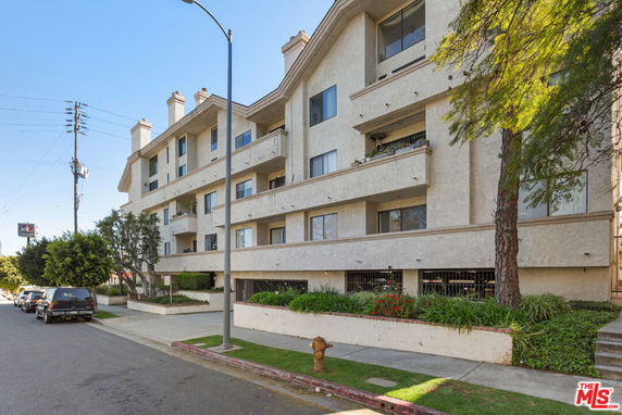 Front view of a multi-story residential building with balconies.