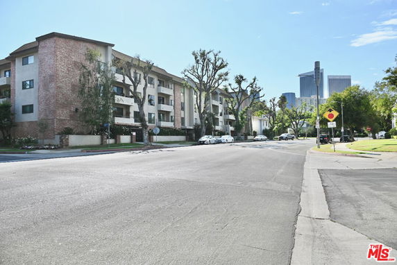 Front view of a multi-story residential building with brick and stucco exterior.