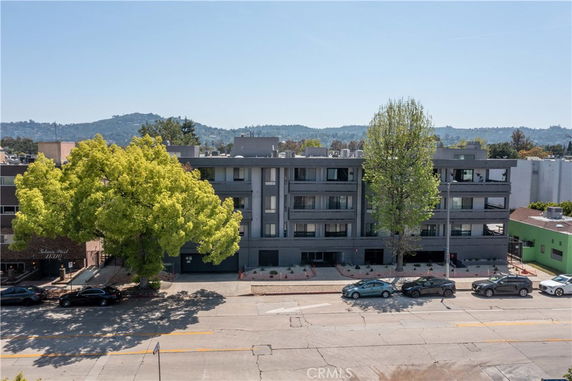 Front view of a multi-story apartment building with balconies.