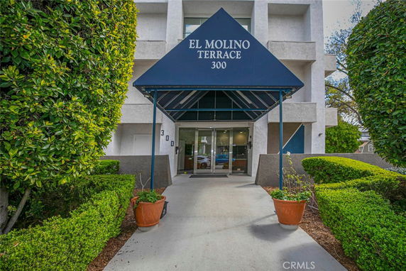 Front entrance of a building with an awning labeled 'El Molino Terrace 300'.