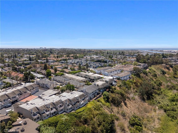 Wide angle view of residential area with multiple buildings and greenery.