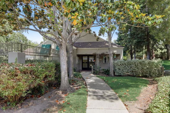 Front view of a small building with a pathway leading to the entrance.