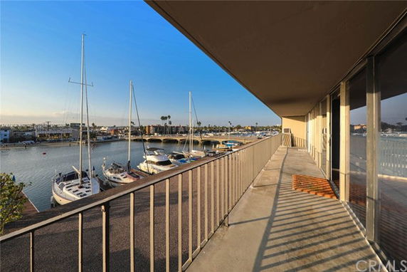 Panoramic view of a marina with boats seen from a balcony.