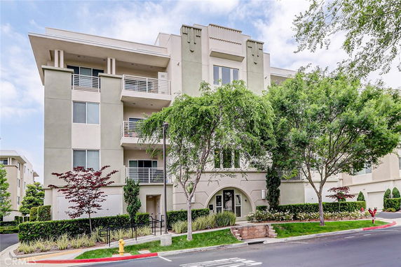 Front view of a multi-story residential building with balconies.