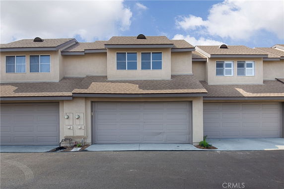 Front view of a townhouse with multiple garages.