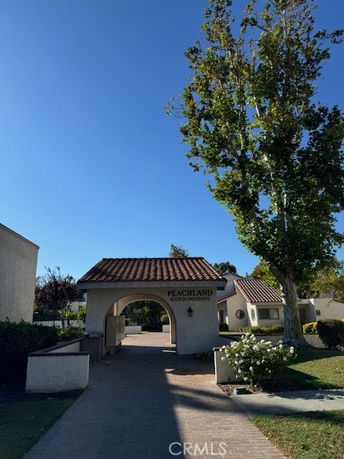 Front view of Peachland condominiums with an arched entrance and tile roof.