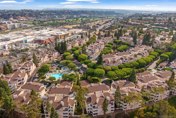Aerial view of a residential complex with multiple buildings and a central swimming pool.