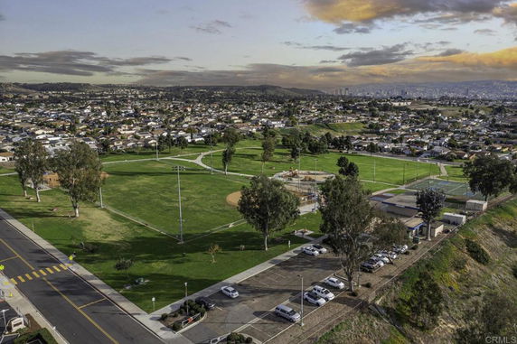 Aerial view of a large park area with sports fields, playground, and nearby residential neighborhood.