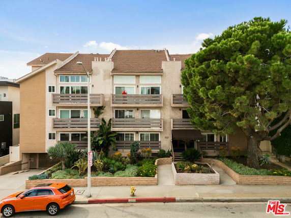 Front view of a multi-level residential building with balconies.