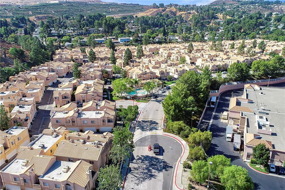 Aerial view of a residential complex with multiple buildings and surrounding greenery.