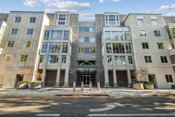 Front view of a multi-story building with large glass windows and modern design.