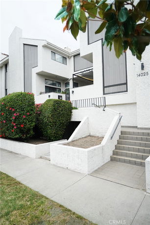 Front view of a multi-story building with white exterior and modern design.