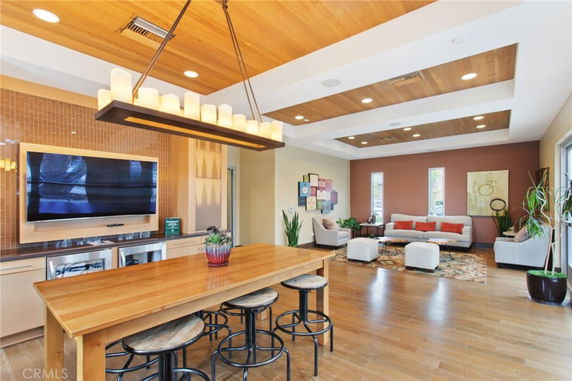 Recreational area with seating and a large table, featuring modern lighting and decor.