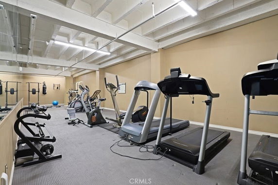 Indoor gym area with exercise equipment such as treadmills and elliptical machines.