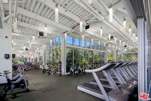 Interior view of a fitness center with multiple treadmills and exercise bikes.