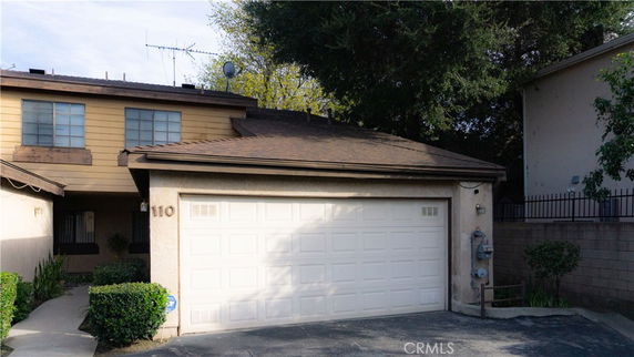 Front view of a two-story house with an attached garage.