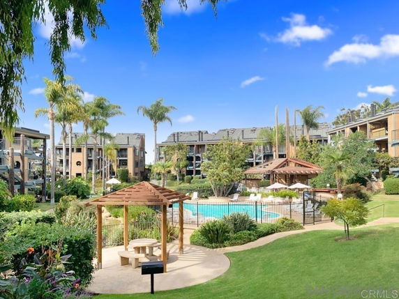 Outdoor area with a swimming pool surrounded by apartment buildings.