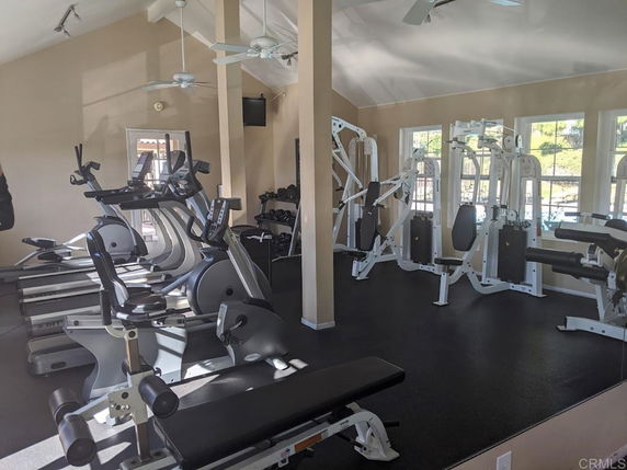 Indoor gym area with exercise machines and equipment.