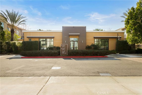 Front view of a single-story building with large windows and a central entrance.