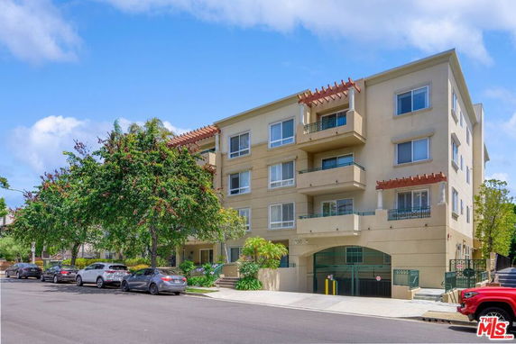 Front view of a multi-story residential building with balconies.
