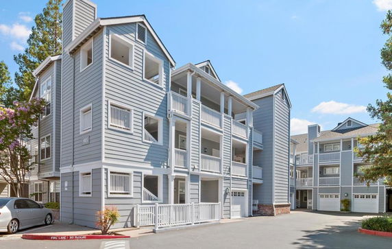 Front view of a multi-story residential building with balconies.