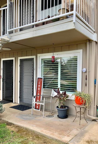 Front view of a ground-floor apartment with a small patio area.