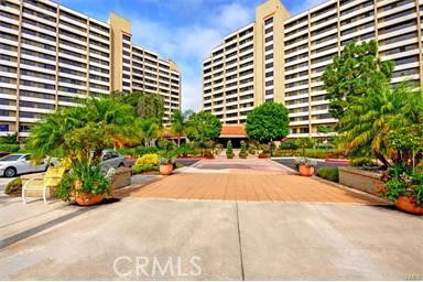 Front view of two high-rise residential buildings with balconies.
