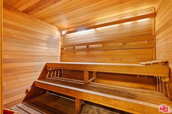 Interior view of a wooden sauna room with bench seating.