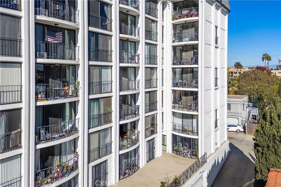 Exterior view of a multi-story apartment building with balconies.