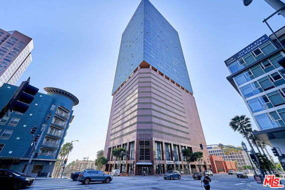 Front view of a tall multi-story building with a distinctive design.